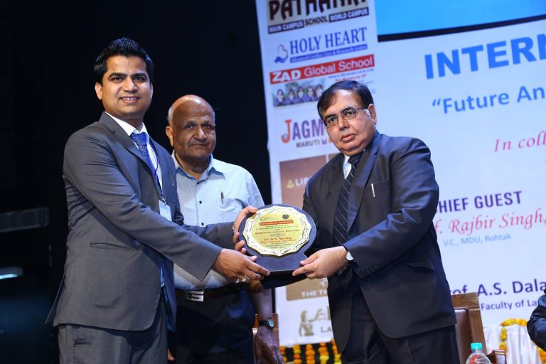 Advocate Naveen Arya receiving recognition on stage